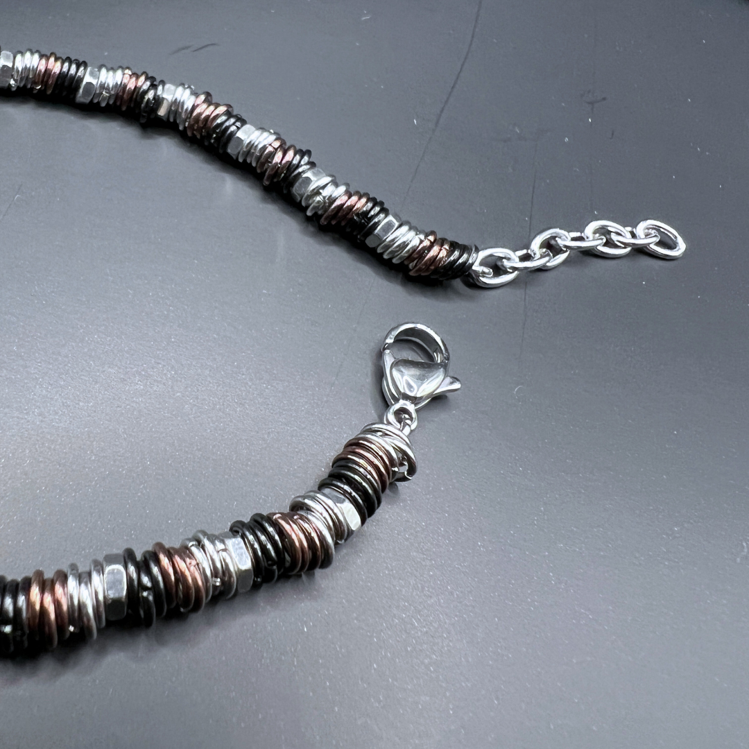Clasp and extension chain detail of the Industrial Torque bracelet variant on black background