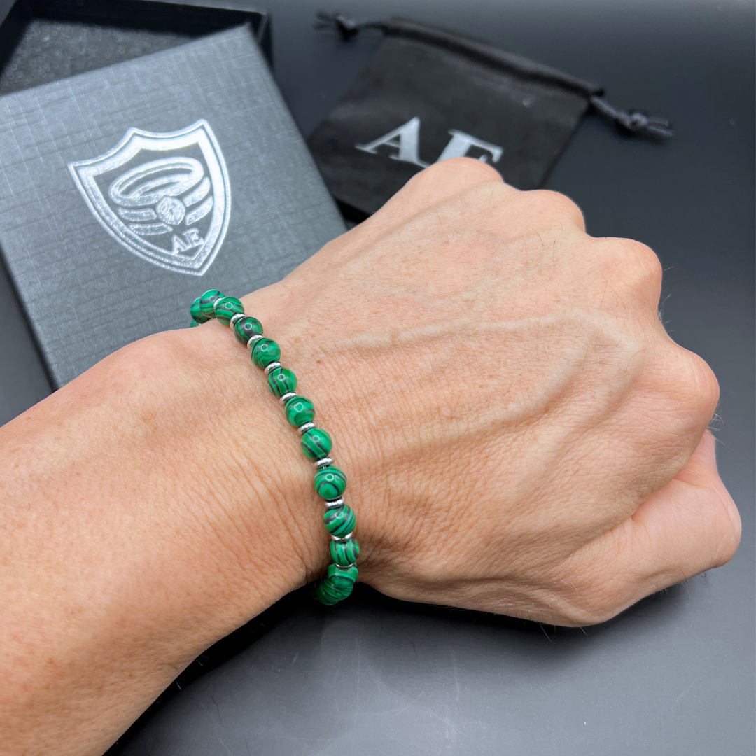 Verdure malachite bead bracelet shown on wrist with Armoured Elegance box