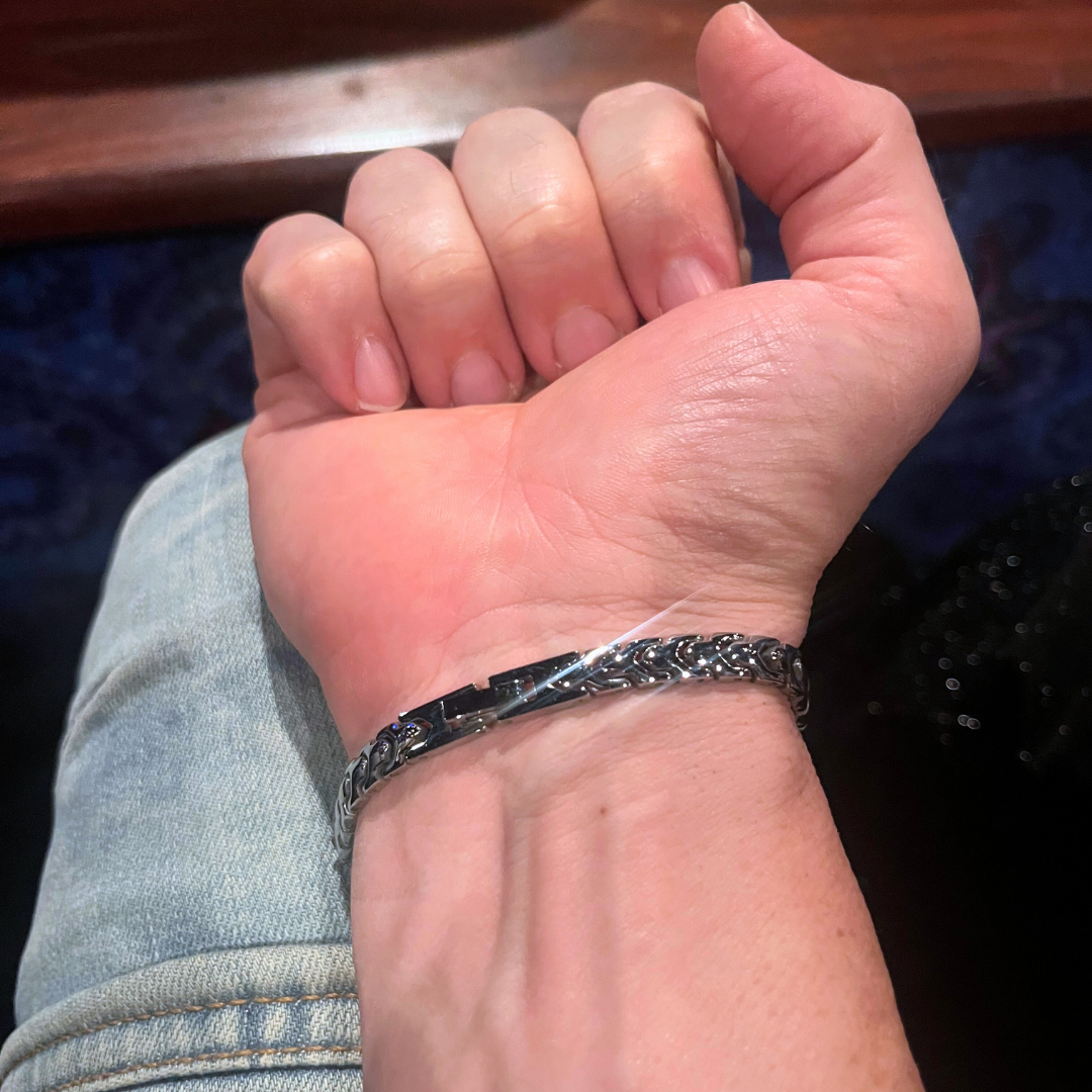 Reverse view of the Aegon bracelet clasped on a man's wrist, showcasing the intricate chain design and secure clasp mechanism.