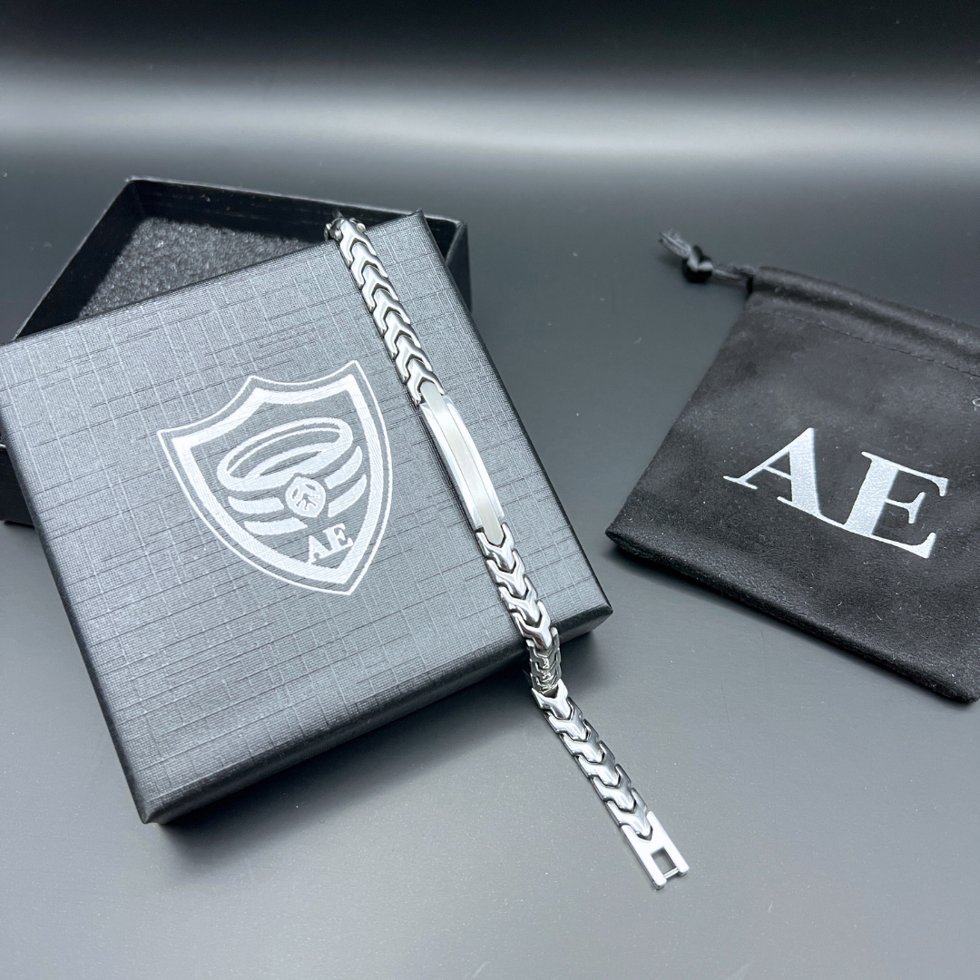 Aegon stainless steel chain bracelet displayed with Armoured Elegance branded gift box and pouch on black background.