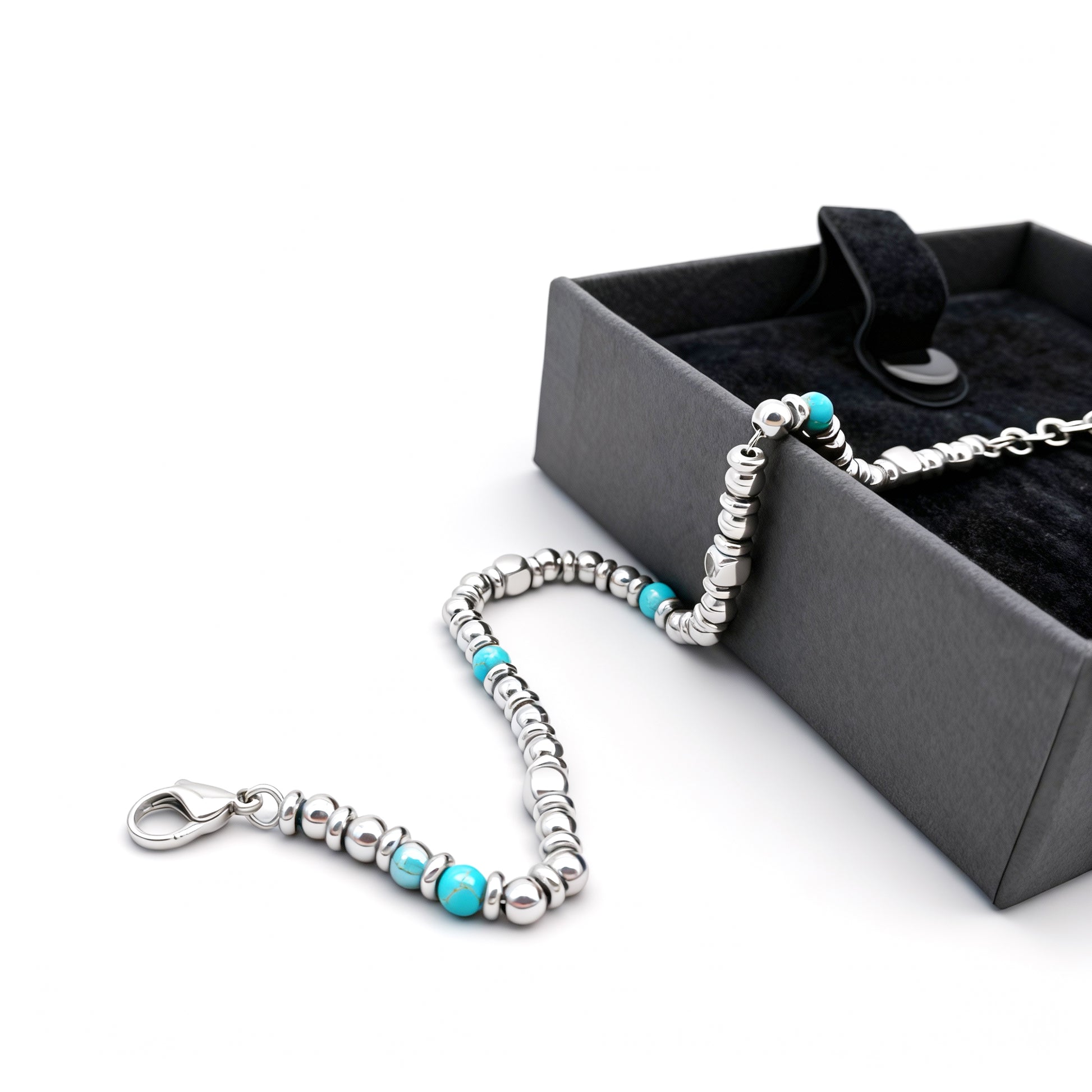 Aqua Pulse bracelet with turquoise stones and silver stainless-steel beads draped over a black gift box showcasing premium presentation.