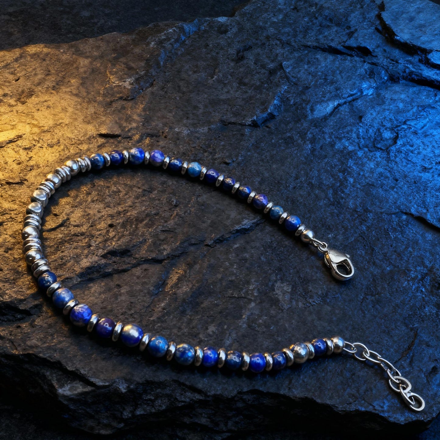Arctic Luxe bracelet photographed on dark textured stone with contrasting warm and cool lighting.