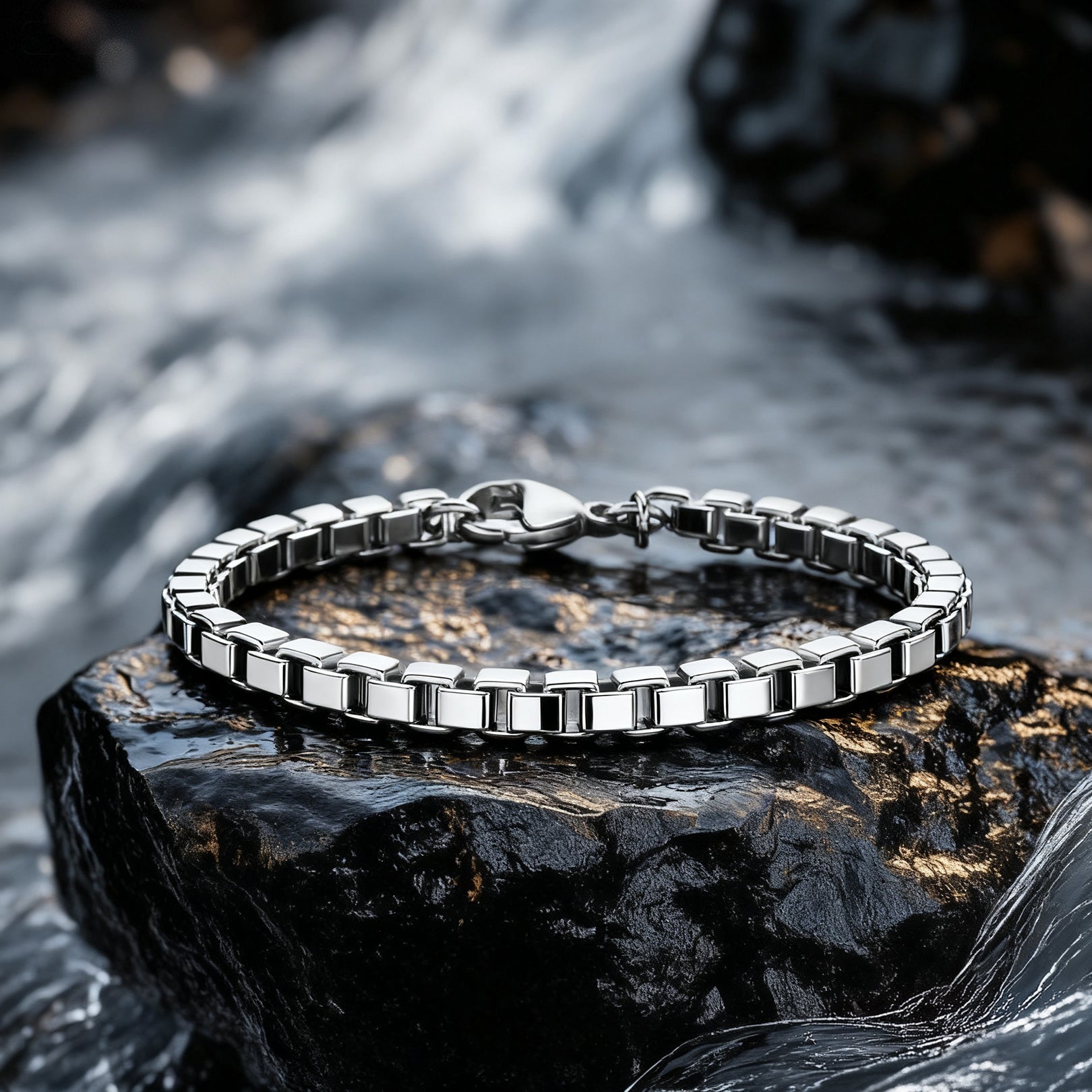 Element stainless steel box chain men's bracelet displayed on wet rock with waterfall background — rugged modern jewellery.
