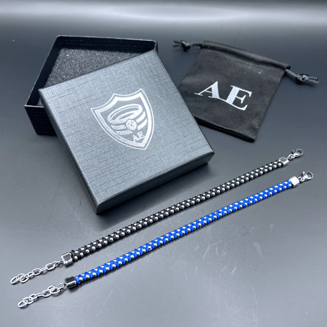 Synergy bracelet set by Armoured Elegance featuring blue and black woven stainless steel bead designs shown with gift box and pouch.