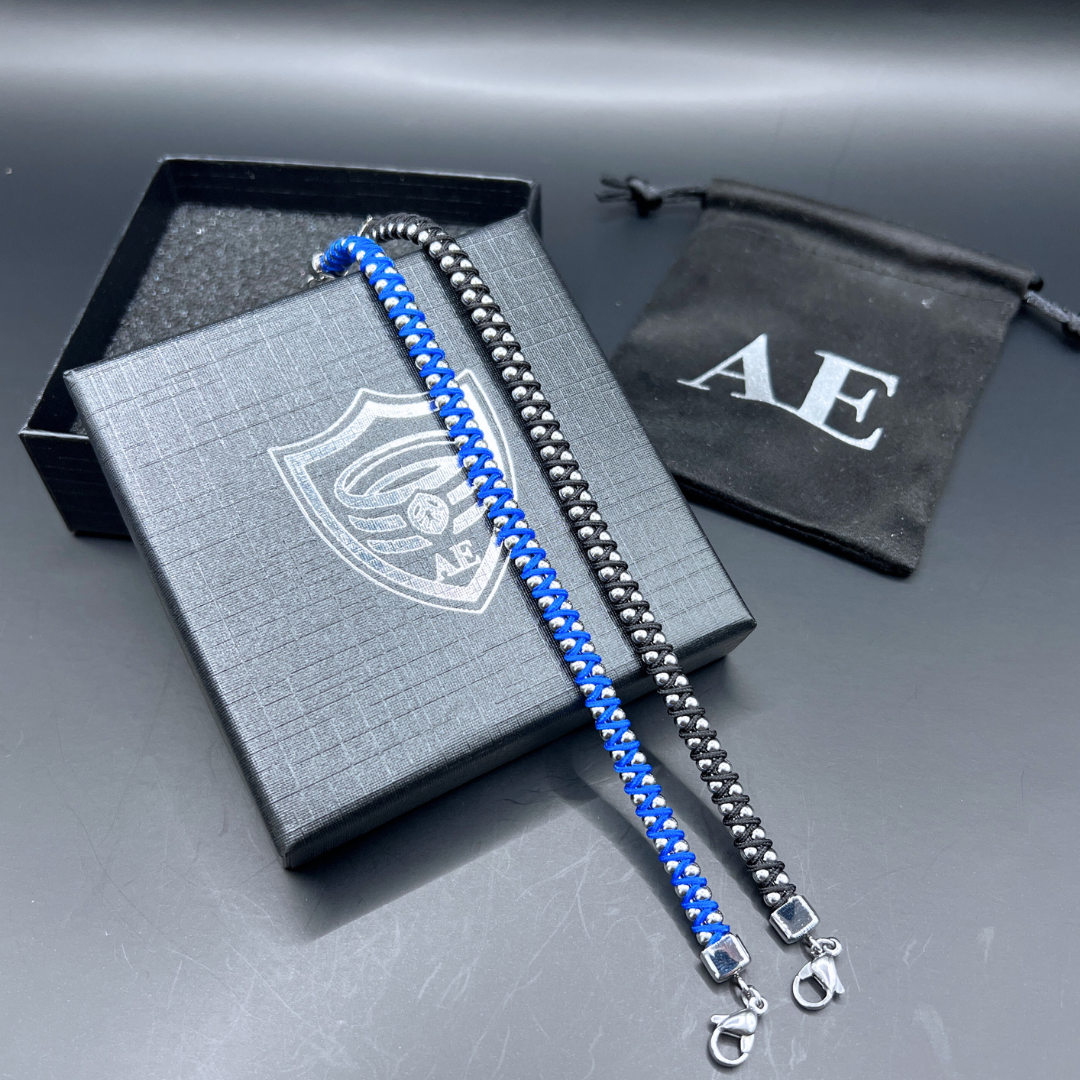 Blue and black Synergy bracelets displayed on Armoured Elegance gift box with stainless steel bead detailing.