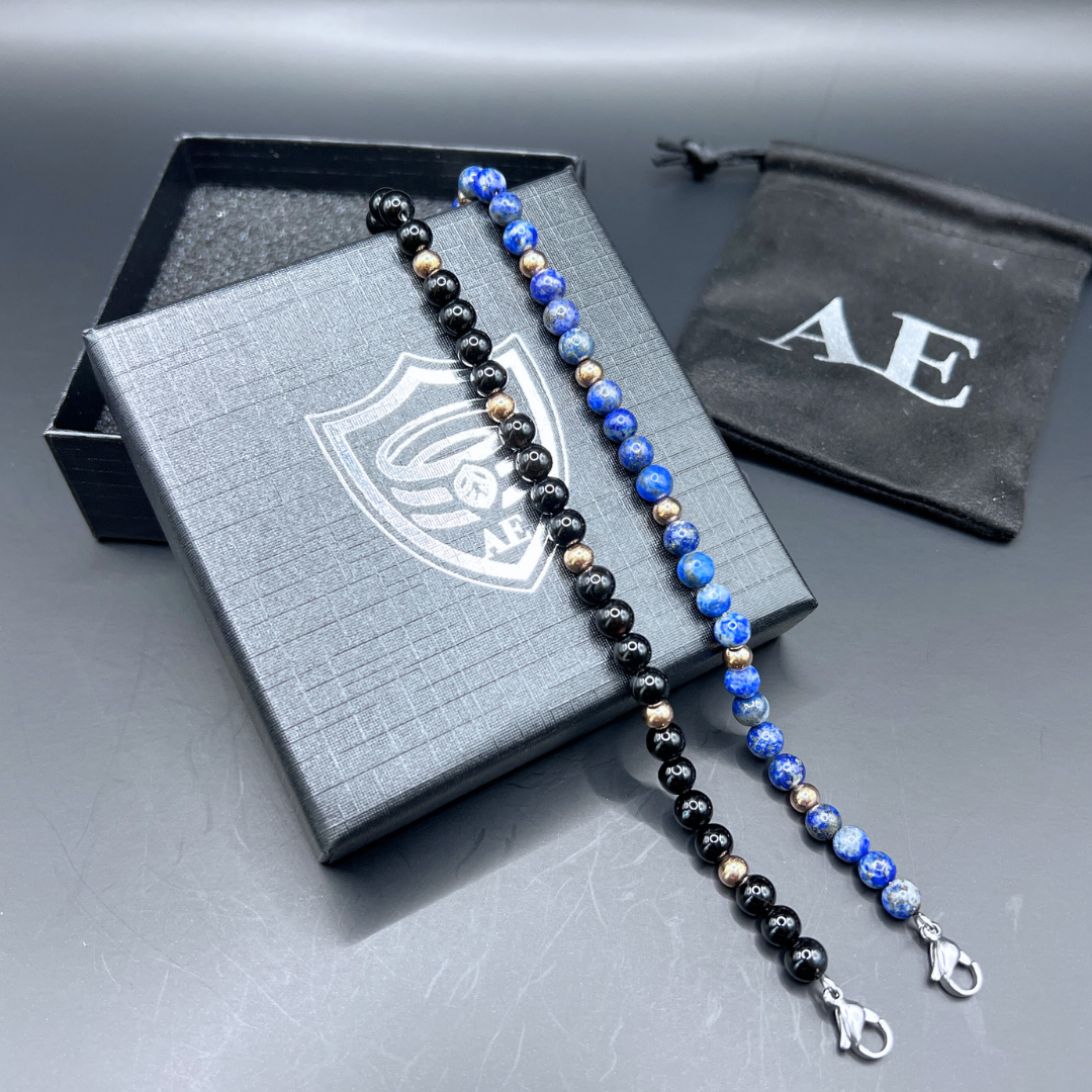 Auric Lineage bead bracelet collection displayed on black Armoured Elegance gift box with pouch.