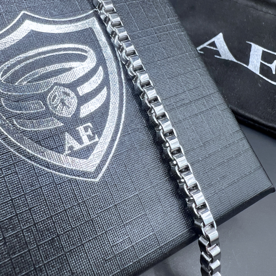 Close-up detail of the Element stainless steel box-chain bracelet showing polished squared links.