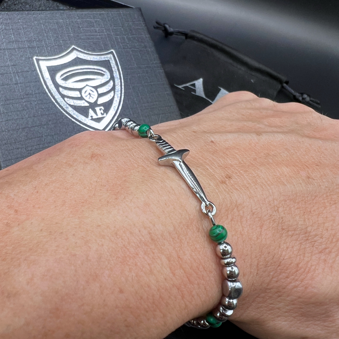 Wrist shot of the Legion bracelet highlighting malachite stones and polished stainless steel elements.