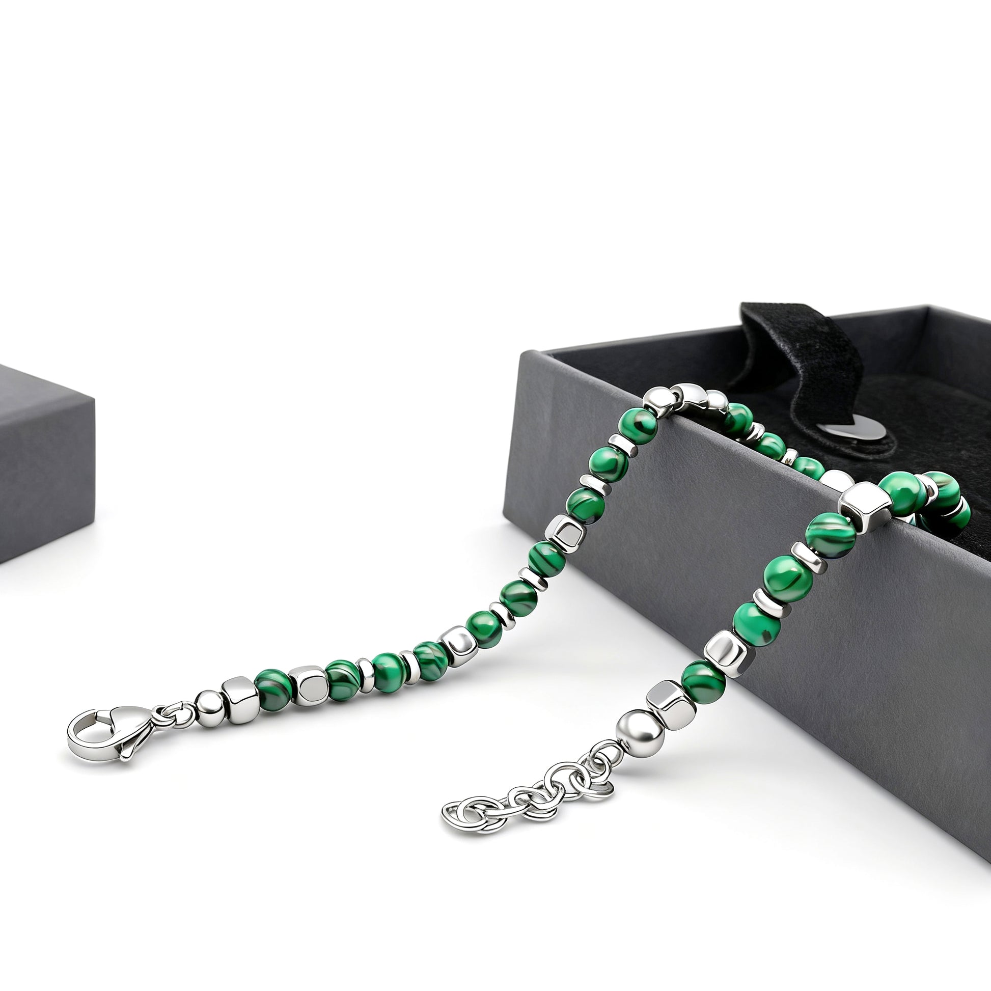 Malachite Luxe bracelet presented beside black gift box showing detailed green malachite stones and polished stainless-steel accents.