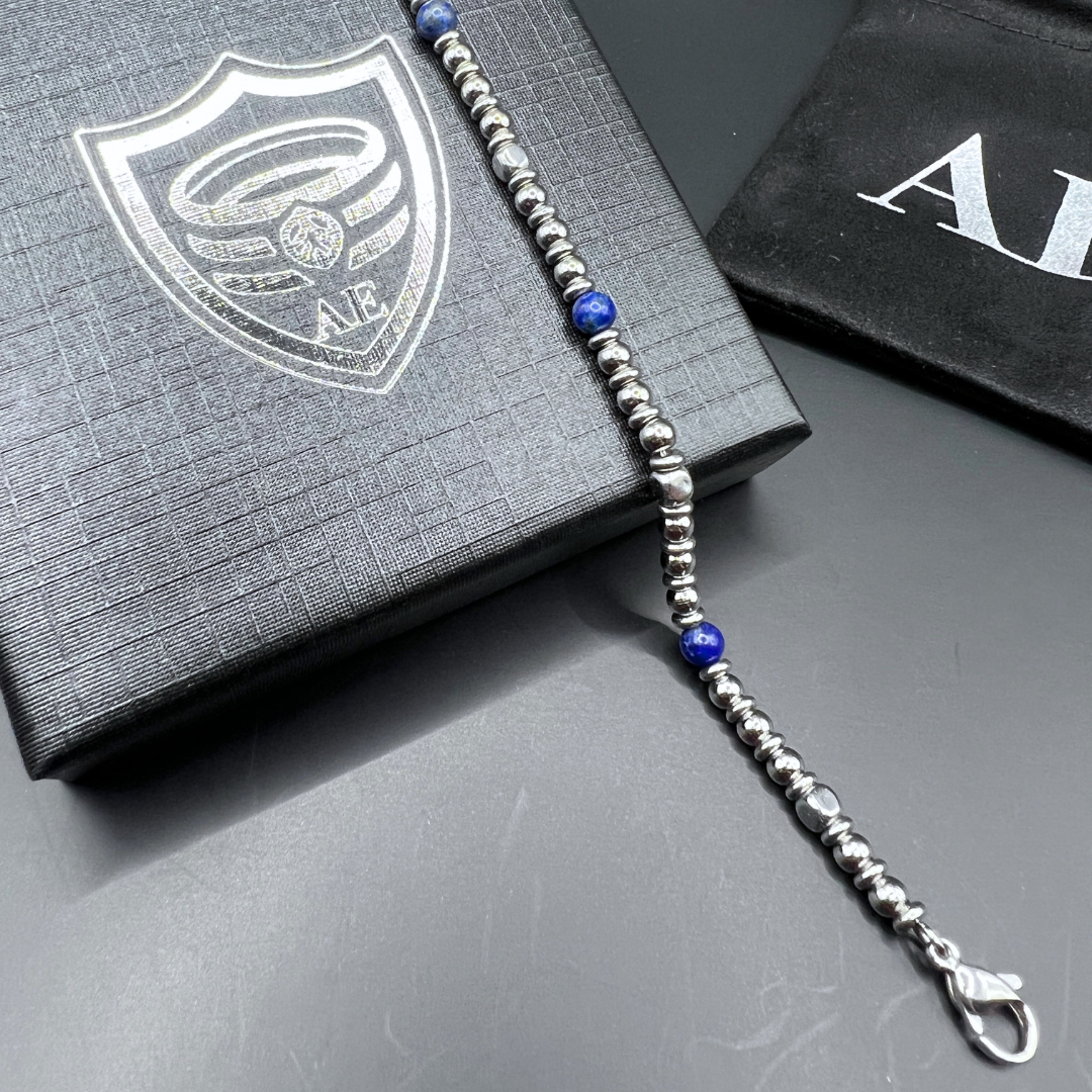 Angled view of Midnight Pulse bracelet on box with Armoured Elegance pouch