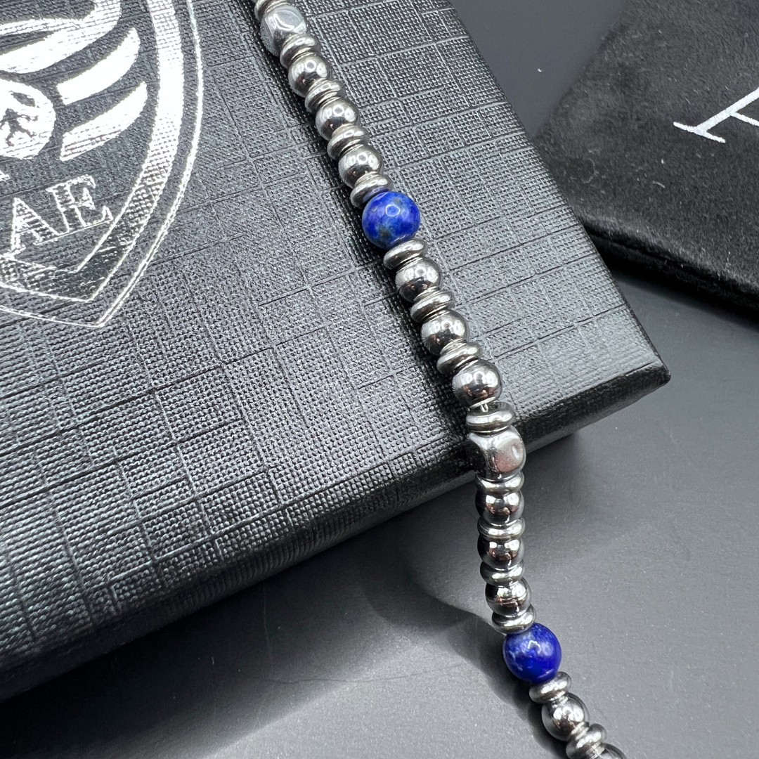 Close-up of Midnight Pulse bracelet featuring blue stone and stainless steel beads on Armoured Elegance gift box