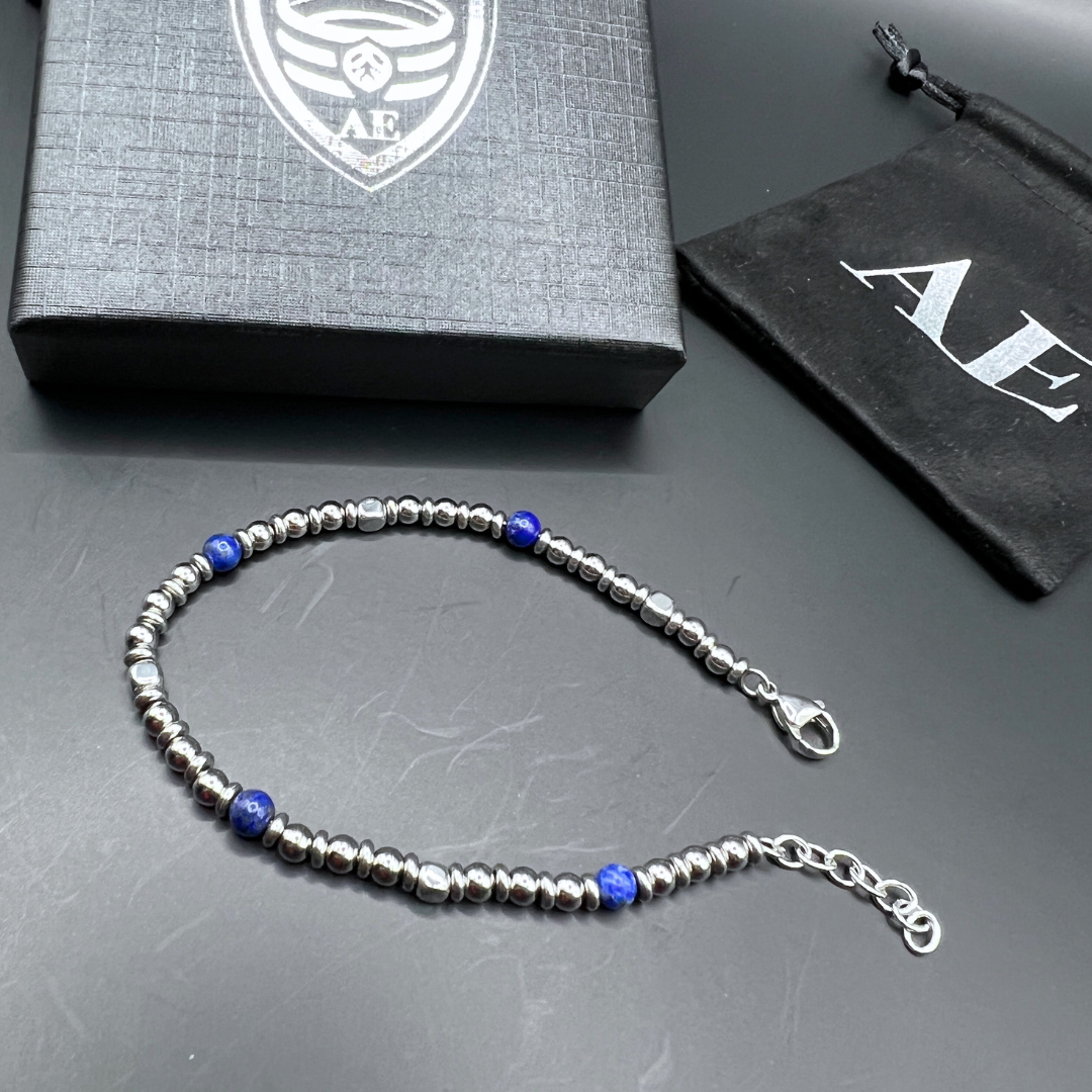 Midnight Pulse bracelet with stainless steel extension chain and clasp shown next to Armoured Elegance packaging