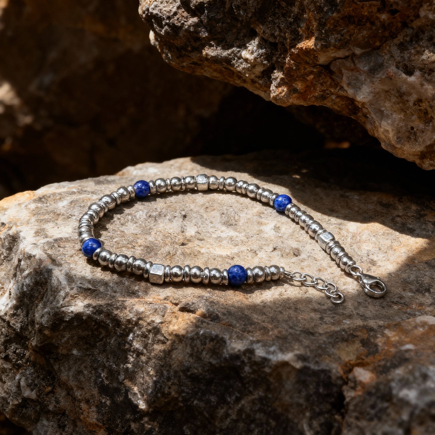 Midnight Pulse bracelet by Armoured Elegance on display in nature on a rock with shadow cast