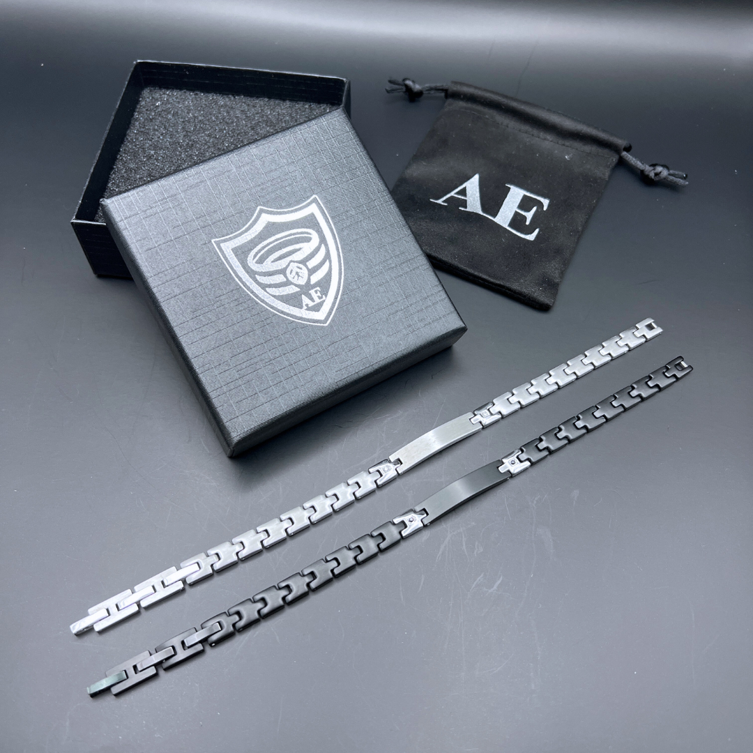 Steel Sentinel and Shadow Sentinel bracelets laid flat highlighting stainless steel links and removable extension pieces