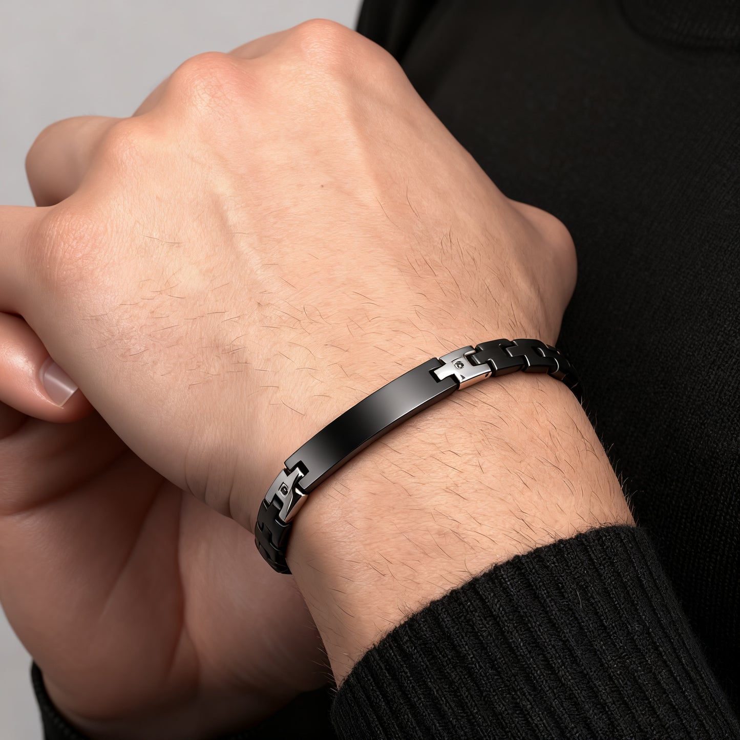 Shadow Sentinel black bracelet worn on wrist, close-up detail showing masculine stainless steel design.