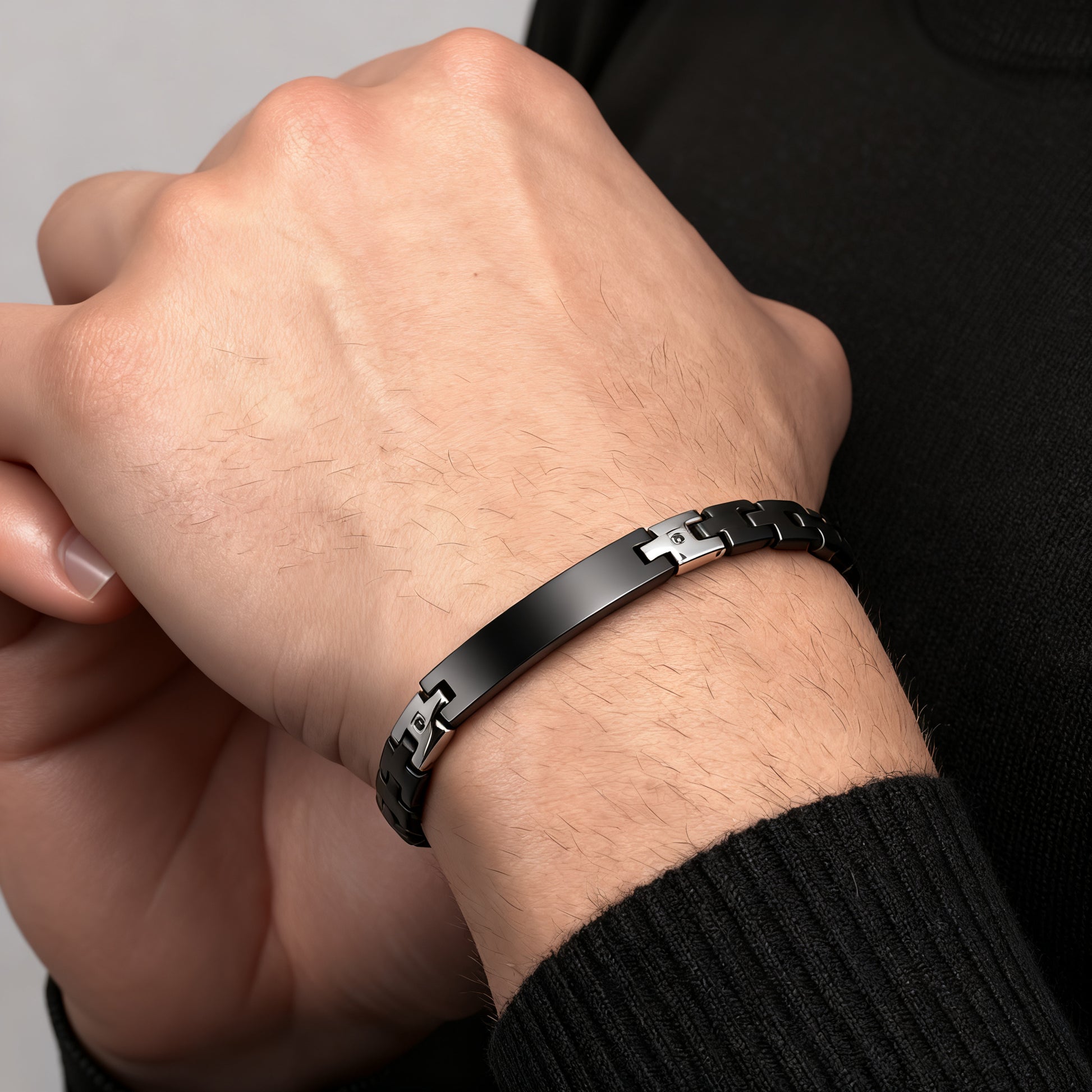 Shadow Sentinel black bracelet worn on wrist, close-up detail showing masculine stainless steel design.