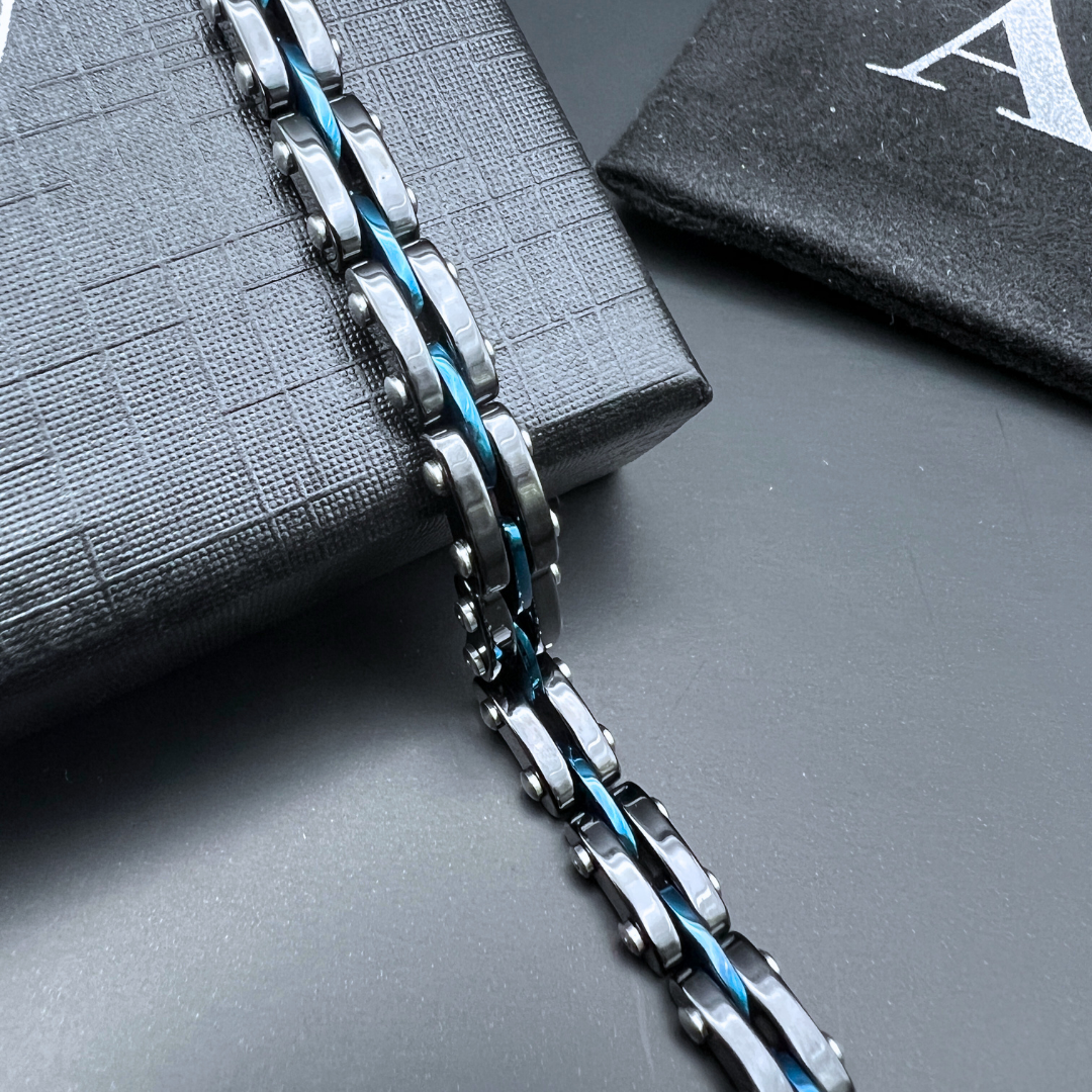 Angled display shot of Velocity Blue Surge bracelet draped over gift box with AE pouch.