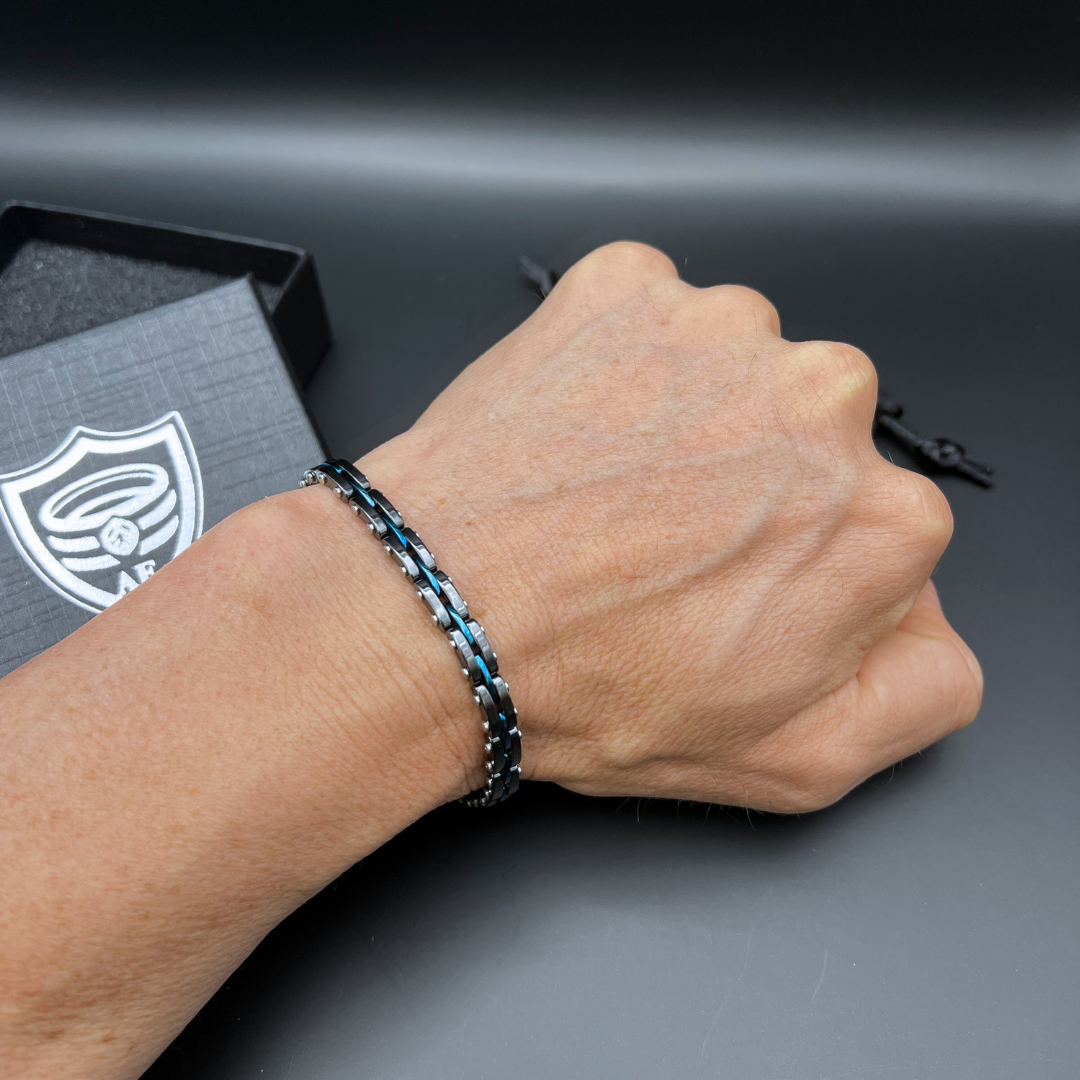 Top down wrist view of Velocity Blue Surge bracelet with subtle chain detail.