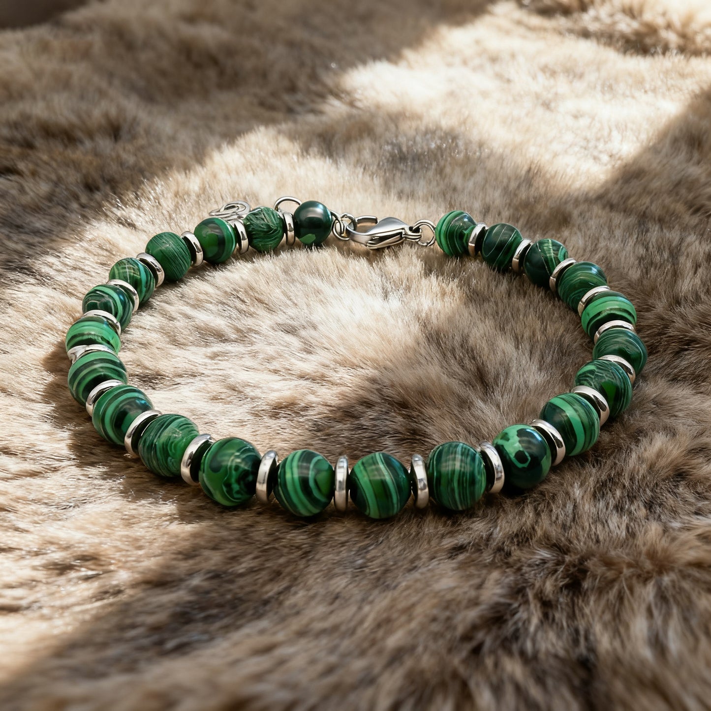 Verdure green stone bead bracelet displayed on soft fur fabric for a luxury aesthetic.